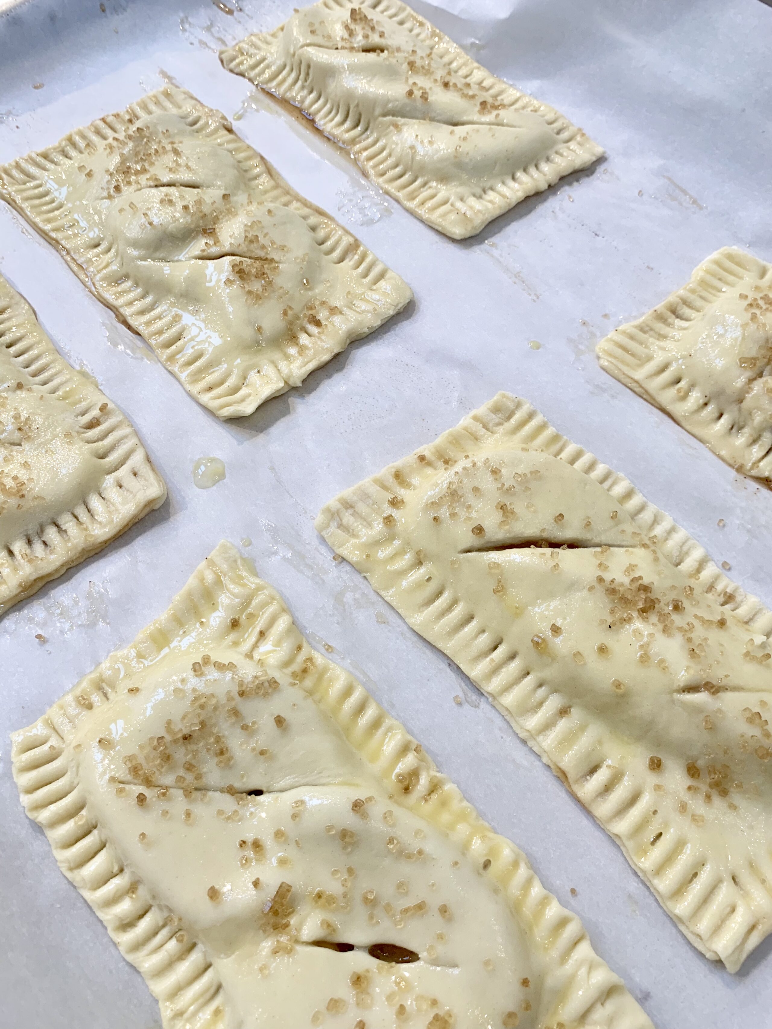 brushing the top of apple hand pies