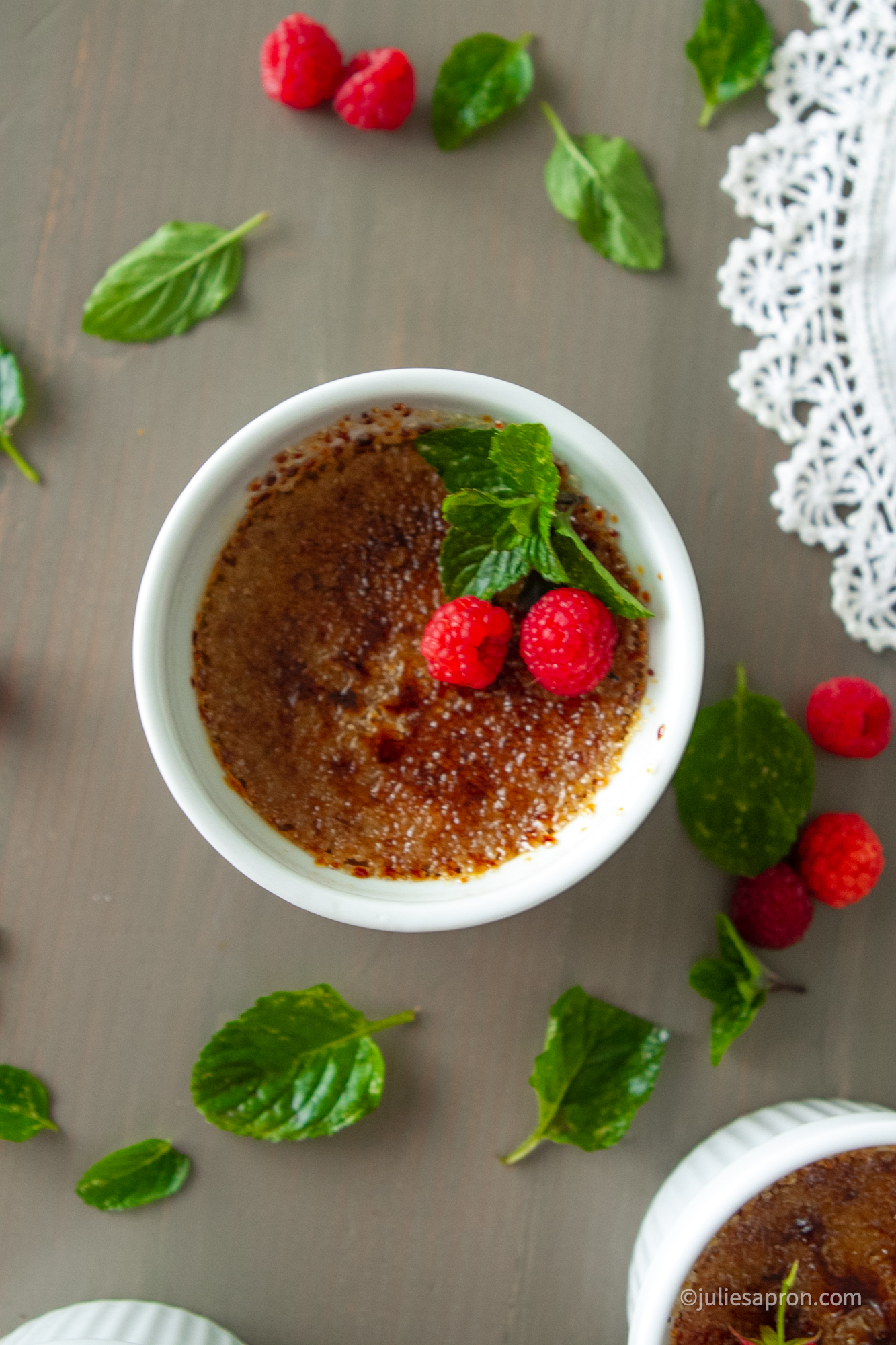 creme brûlée with mint leaf and raspberries