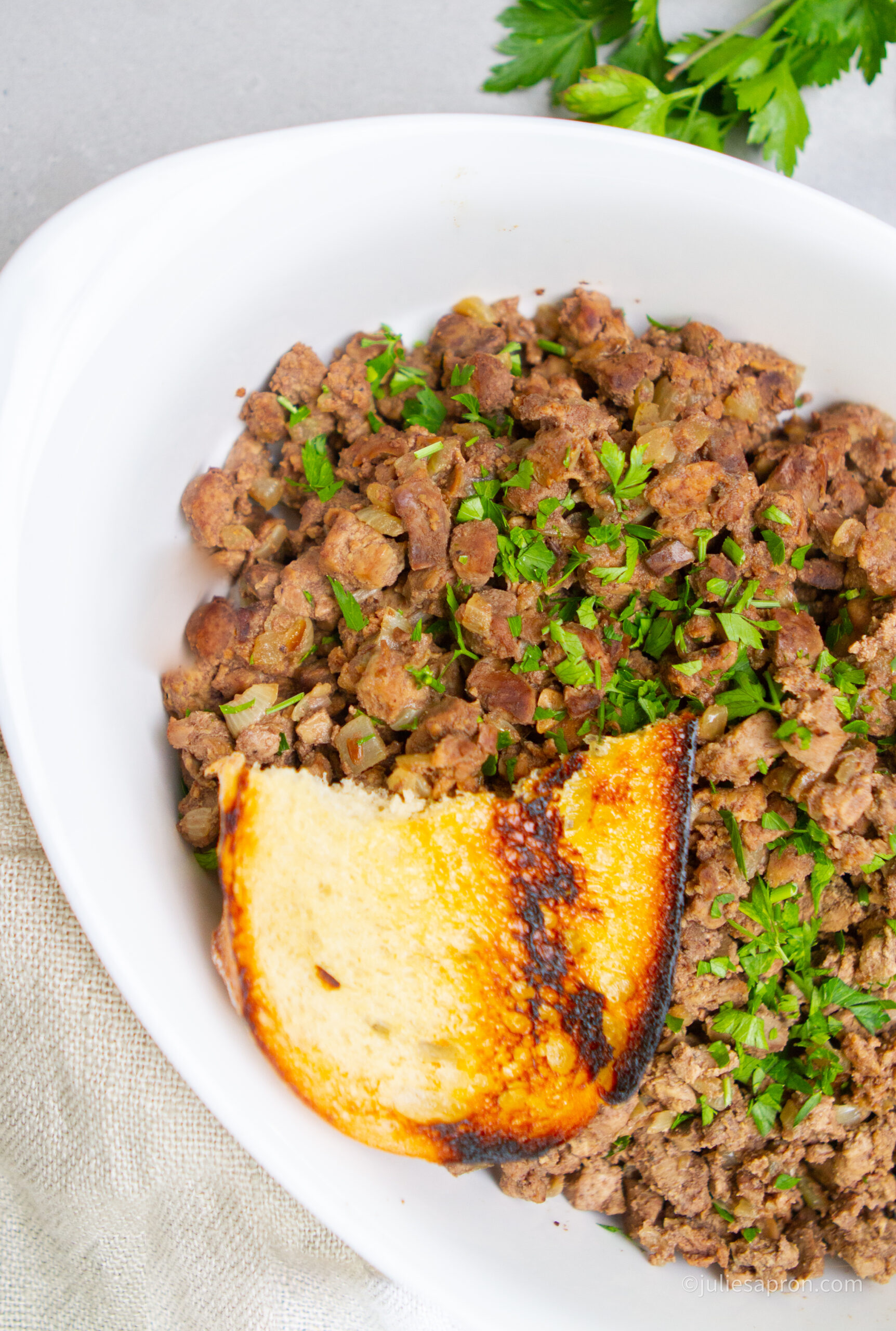 liver in white bowl with crispy toast