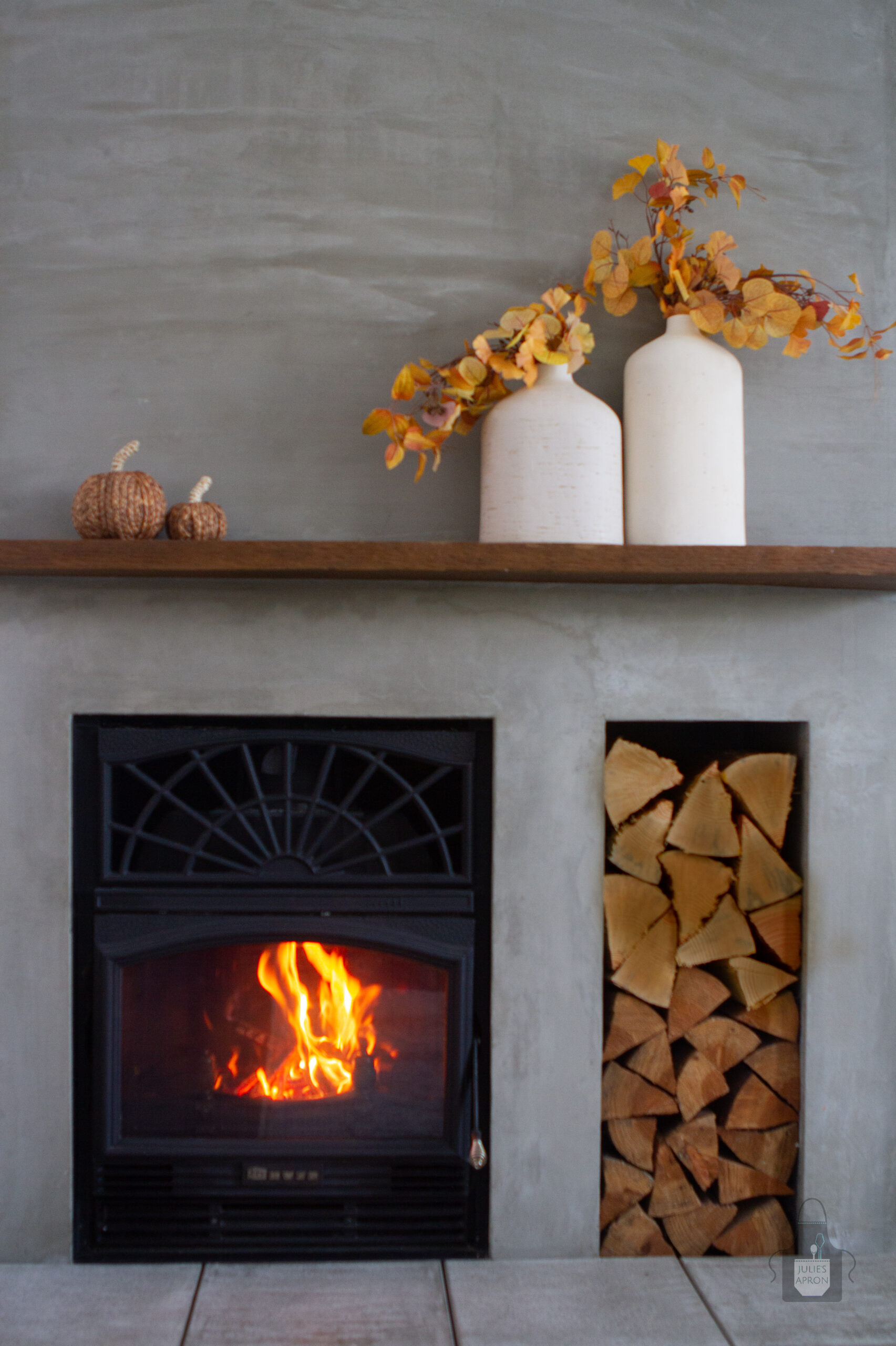 fireplace with fall decor on mantel