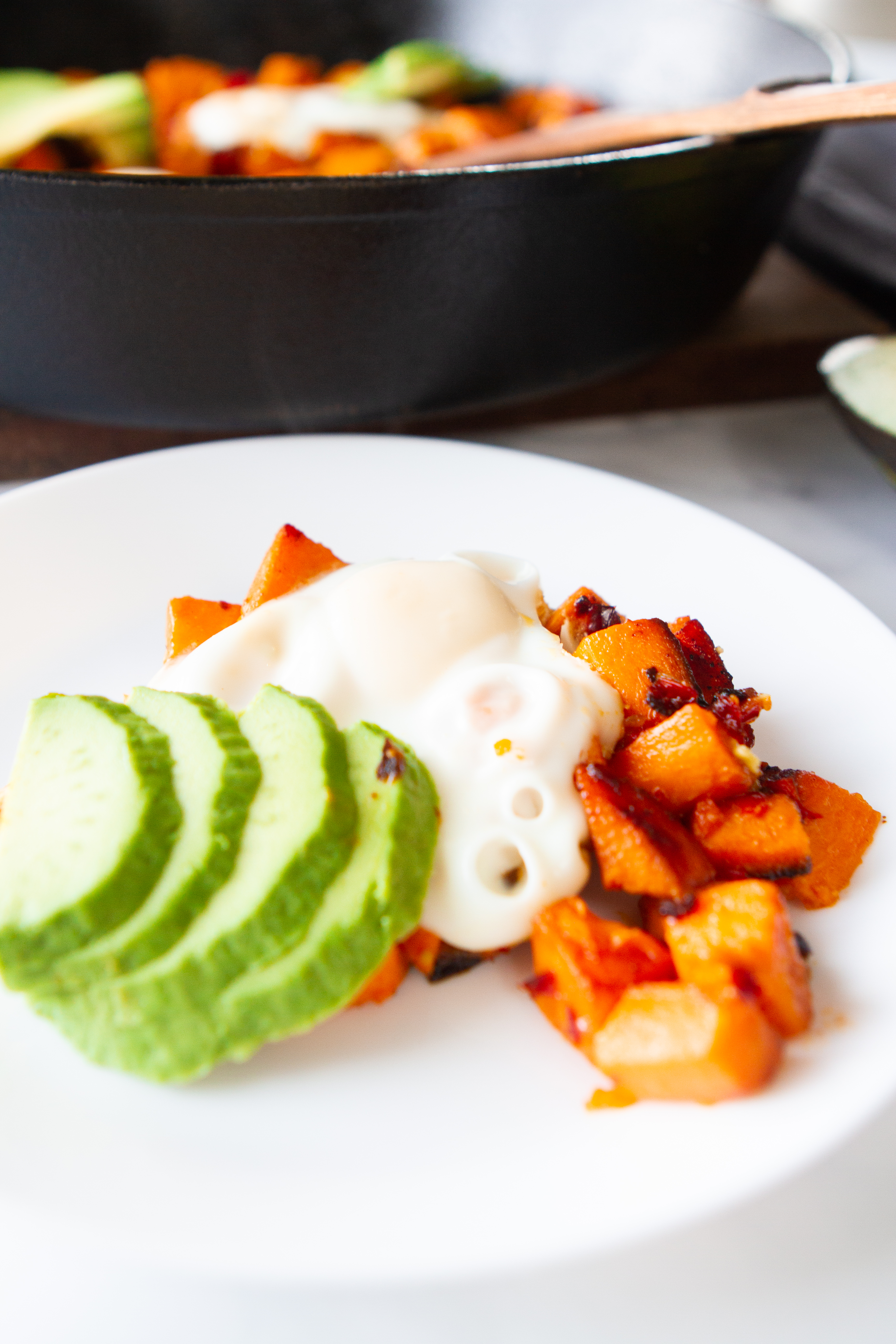 plated sweet potatoes with egg and avocado