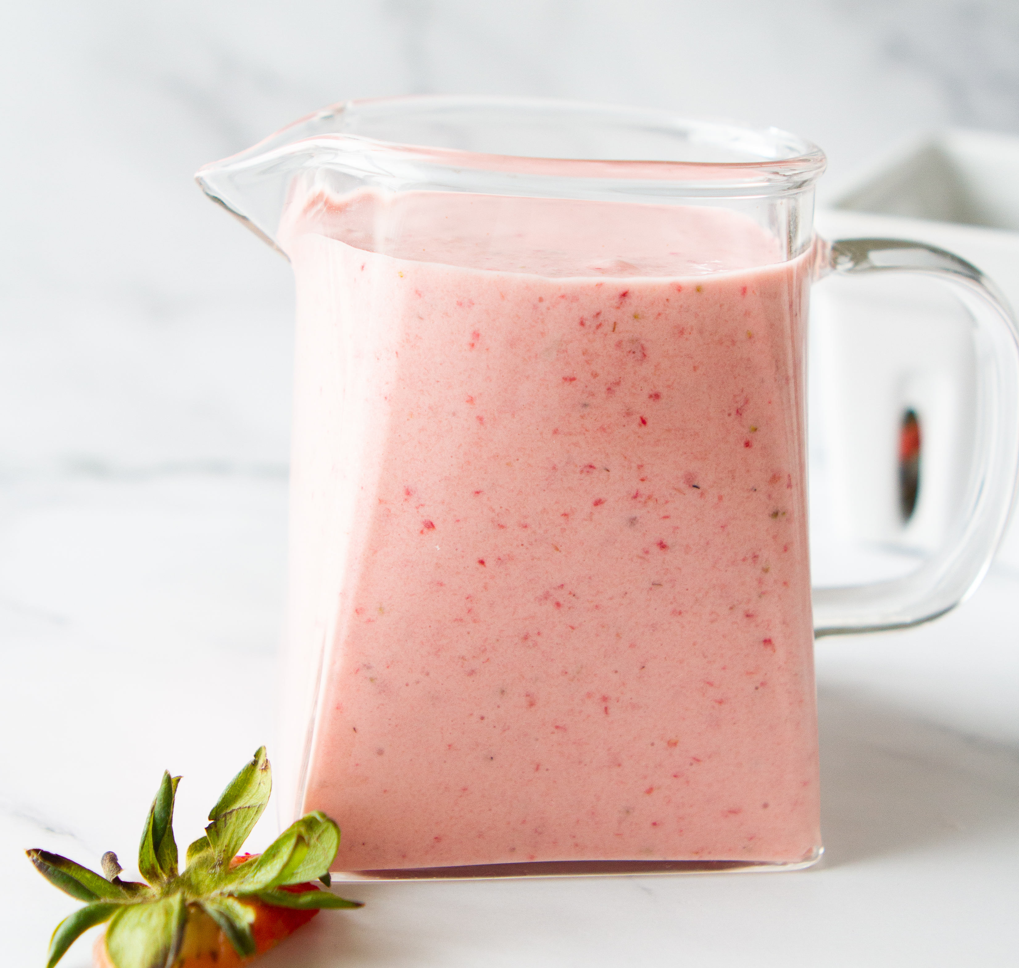 creamy strawberries in a glass pitcher