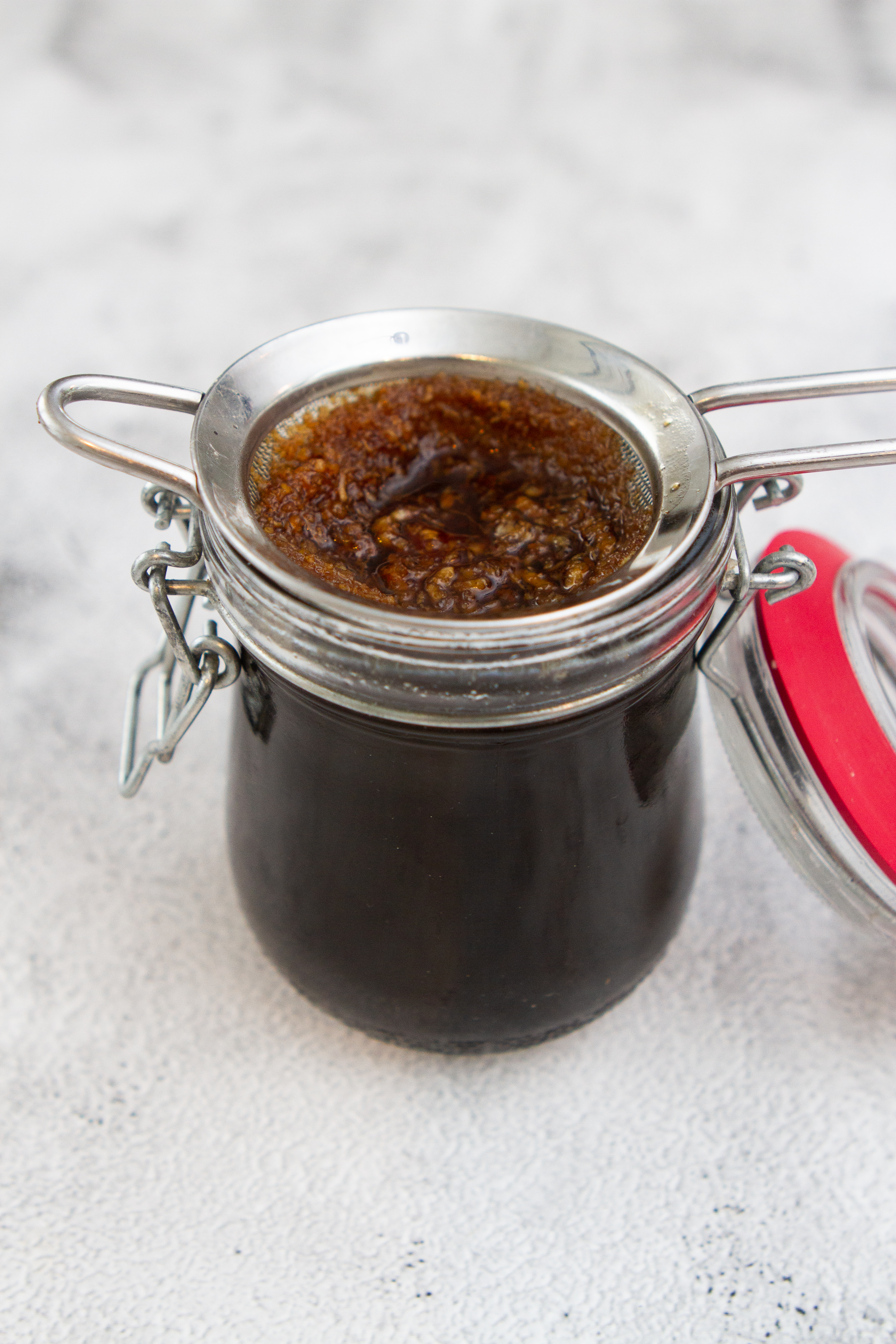 straining yakisoba sauce into a jar