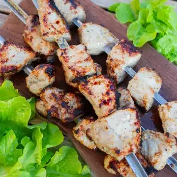 Pork tenderloin kebabs on wood cutting board