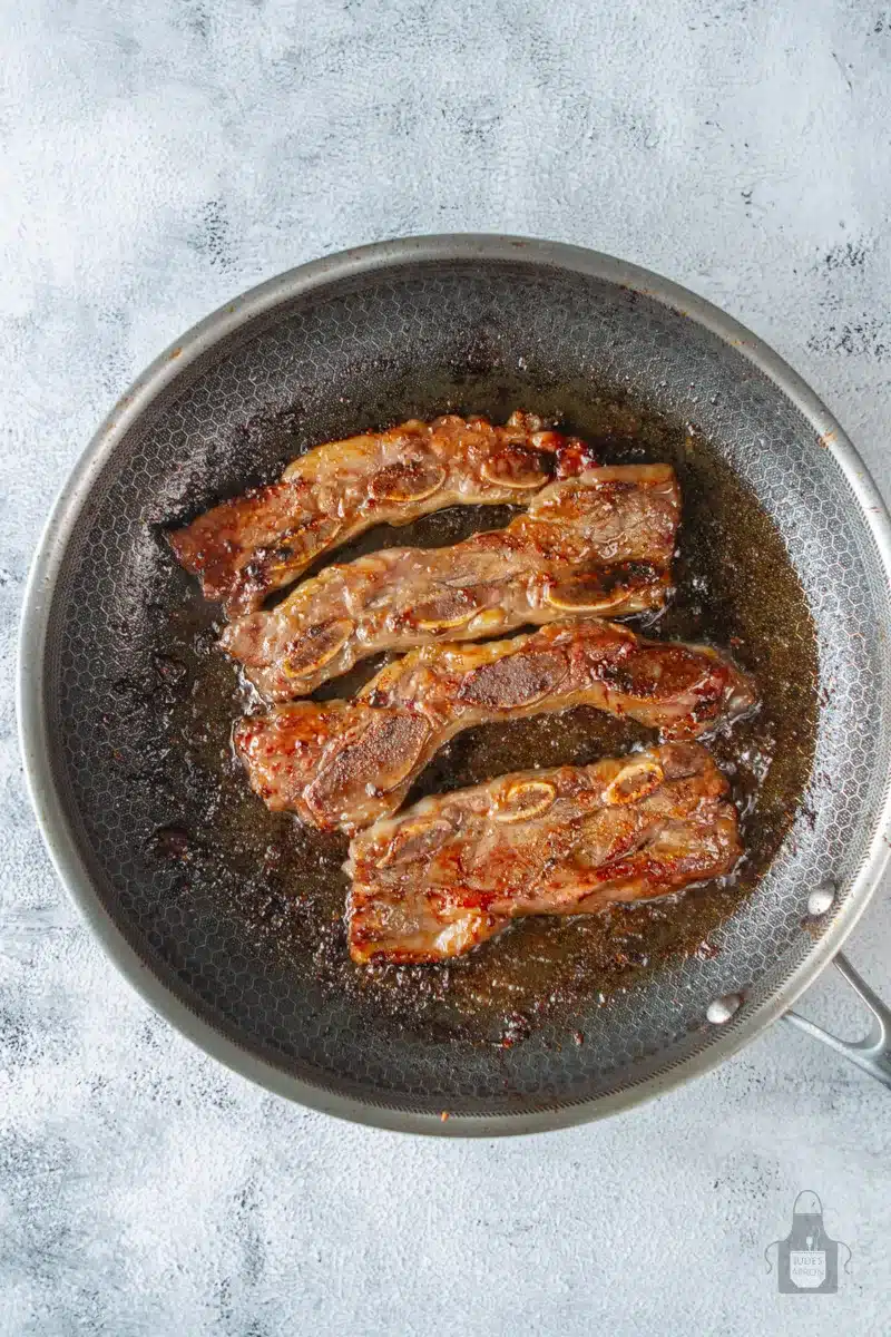 sautéed short ribs in a pan