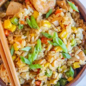 fried rice with shrimp and chicken in a wooden bowl