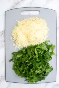 grated parmesan cheese and chopped spinach