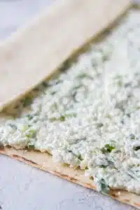 spread herbed cottage cheese onto lavash