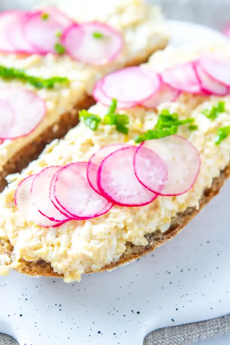 egg salad sandwich garnished with radish