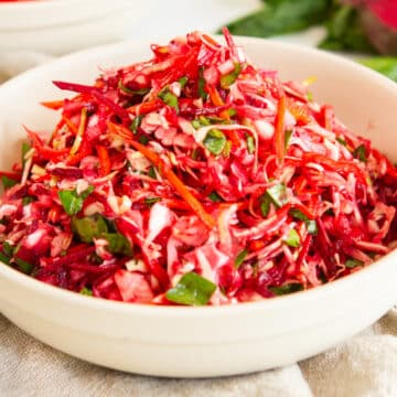 Fresh beet coleslaw salad with shredded beets and crisp vegetables, a healthy homemade side dish perfect for summer meals and clean eating