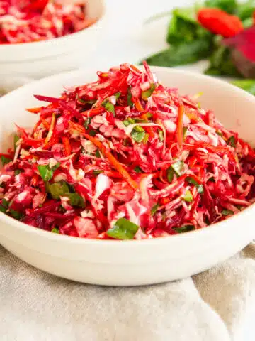 Fresh beet coleslaw salad with shredded beets and crisp vegetables, a healthy homemade side dish perfect for summer meals and clean eating