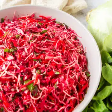 raw beets with cabbage carrots and other veggies in a bowl