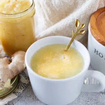 organic lemon ginger honey tea in a white tea cup